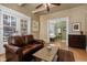 Cozy living room showcases a comfortable leather sofa, hardwood floors, and seamless flow into the bedroom at 1301 N Ogden St # 1A, Denver, CO 80218