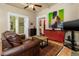 Inviting living room featuring hardwood floors, a fireplace, and colorful artwork, with seamless flow to other rooms at 1301 N Ogden St # 1A, Denver, CO 80218