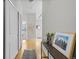 Bright hallway with hardwood floors and a console table with decorative items at 7240 W Custer Ave # 119, Lakewood, CO 80226