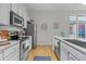 Updated kitchen featuring stainless steel appliances, light countertops and wood floors at 7240 W Custer Ave # 119, Lakewood, CO 80226