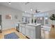 Stylish kitchen island with stainless steel sink, dishwasher, and adjacent access to the outdoor deck at 7240 W Custer Ave # 119, Lakewood, CO 80226