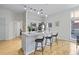 Bright kitchen with a breakfast bar, white cabinets, modern lighting, and stainless steel appliances at 7240 W Custer Ave # 119, Lakewood, CO 80226