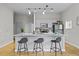 Open kitchen with gray cabinets, stainless steel appliances and an island with three chairs at 7240 W Custer Ave # 119, Lakewood, CO 80226