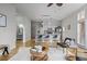 Open-concept living room featuring hardwood floors, modern furnishings, and access to a stylish kitchen at 7240 W Custer Ave # 119, Lakewood, CO 80226