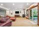 Basement living area with leather seating, a wood-burning stove, and natural light at 14271 Timber Trl, Larkspur, CO 80118
