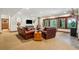 Basement living space with a fireplace, comfortable seating, and windows to the outdoor scenery at 14271 Timber Trl, Larkspur, CO 80118