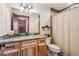 Bathroom featuring wood cabinetry, granite countertop, and neutral-toned tile with shower at 14271 Timber Trl, Larkspur, CO 80118