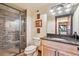 Bathroom featuring tiled shower, granite counters, modern fixtures, and framed decorative wall art at 14271 Timber Trl, Larkspur, CO 80118