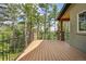 Large wood deck surrounded by mature trees, offering a private outdoor space at 14271 Timber Trl, Larkspur, CO 80118