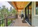 Another angle of the large wood deck with barbecue and outdoor seating at 14271 Timber Trl, Larkspur, CO 80118