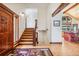 Spacious foyer with wood floors, staircase, and mountain-themed decor at 14271 Timber Trl, Larkspur, CO 80118