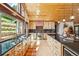 Bright kitchen with custom wood cabinetry, granite countertops, and stainless steel appliances at 14271 Timber Trl, Larkspur, CO 80118