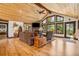 Relax in the living room with a stone fireplace and wood beam ceilings at 14271 Timber Trl, Larkspur, CO 80118