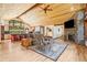 The open layout offers a seamless flow between living room and kitchen with a cozy stacked stone fireplace feature at 14271 Timber Trl, Larkspur, CO 80118