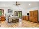 Cozy main bedroom with wood floors, balcony access, and ample natural light at 14271 Timber Trl, Larkspur, CO 80118