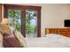Close up view of Main Bedroom with french doors leading to the deck and views of the landscape at 14271 Timber Trl, Larkspur, CO 80118