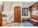 Mud room with coat hooks, storage, bench seating and natural light from the window at 14271 Timber Trl, Larkspur, CO 80118