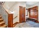 Mud room with coat hooks, storage, and bench seating, located near the staircase at 14271 Timber Trl, Larkspur, CO 80118