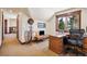 Bright office space with built-in desk, unique decor, and a view of the natural landscape at 14271 Timber Trl, Larkspur, CO 80118