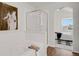 Modern bathroom featuring soaking tub, glass-enclosed shower and adjoined bedroom with arch doorway at 1443 S Emporia Ct, Aurora, CO 80247