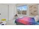 Bright bedroom with a large window, closet and colorful galaxy-themed bedding at 1443 S Emporia Ct, Aurora, CO 80247