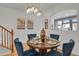 Stylish dining area features a round table, elegant blue chairs, and attractive decor at 1443 S Emporia Ct, Aurora, CO 80247