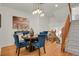 Elegant dining area with hardwood floors, stylish light fixture, and staircase access at 1443 S Emporia Ct, Aurora, CO 80247