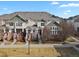 Inviting townhouse exterior featuring well-maintained lawns, brick accents, and charming entrances at 1443 S Emporia Ct, Aurora, CO 80247