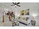 Bright living room with open staircase, neutral decor, and a comfortable seating area at 1443 S Emporia Ct, Aurora, CO 80247