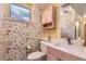 Charming bathroom with floral wallpaper, a vanity, and a window at 8292 E Lehigh Dr, Denver, CO 80237