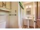 Bathroom with a pedestal sink, a tiled shower and a mirrored vanity at 8292 E Lehigh Dr, Denver, CO 80237