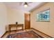 Bedroom featuring hardwood floors, a window with trees outside, and a small wood table at 8292 E Lehigh Dr, Denver, CO 80237