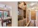 Inviting hallway featuring hardwood floors, built-in shelving, and a view into the dining room at 8292 E Lehigh Dr, Denver, CO 80237