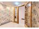 Hallway with glass French doors and patterned wallpaper at 8292 E Lehigh Dr, Denver, CO 80237