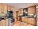 Modern kitchen with stainless steel appliances, granite countertops, updated cabinetry, and hardwood floors at 8292 E Lehigh Dr, Denver, CO 80237