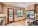 Bright kitchen with a garden window, stainless steel refrigerator, and hardwood floors at 8292 E Lehigh Dr, Denver, CO 80237