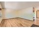 Spacious room with hardwood floors, neutral paint, and a large window offering ample natural light at 8292 E Lehigh Dr, Denver, CO 80237
