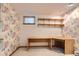 Office featuring a work desk, shelving, and unique patterned wallpaper at 8292 E Lehigh Dr, Denver, CO 80237