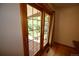 Bright room with hardwood floors and a multi-pane glass patio door that leads to a wooden porch and yard at 8292 E Lehigh Dr, Denver, CO 80237