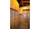 Unfinished storage room with wood walls, overhead cabinets, and a glass-paneled door at 8292 E Lehigh Dr, Denver, CO 80237