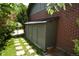 Convenient outdoor storage unit against a brick wall with a walkway to the gate at 8292 E Lehigh Dr, Denver, CO 80237