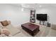 Finished basement features carpet, modern furniture and television setup at 1777 Spruce St, Denver, CO 80220