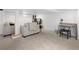 Finished basement with neutral carpet, comfortable seating, and a functional desk area at 1777 Spruce St, Denver, CO 80220