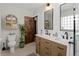 Well-lit bathroom with double vanity, modern fixtures, and a glass-enclosed shower at 1777 Spruce St, Denver, CO 80220