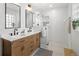 Stylish bathroom with dual sinks, modern fixtures, and a walk-in shower with glass enclosure at 1777 Spruce St, Denver, CO 80220