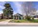 Cozy home with a lush tree and a well-kept lawn at 1777 Spruce St, Denver, CO 80220