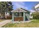 Charming bungalow with a well-maintained front yard and inviting porch at 1777 Spruce St, Denver, CO 80220