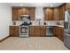 Updated kitchen with wood cabinets, stainless steel appliances, and subway tile backsplash at 1777 Spruce St, Denver, CO 80220