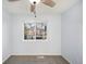 This bedroom features a ceiling fan and a window overlooking the neighborhood at 12603 Eudora St, Thornton, CO 80241