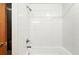 Clean, white tiled bathroom with a shower and tub combination and new fixtures at 2960 Shadow Creek Dr # 201, Boulder, CO 80303